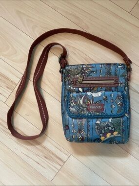 Sakroots Teal “Peace Print” Crossbody Bag with Brown Strap